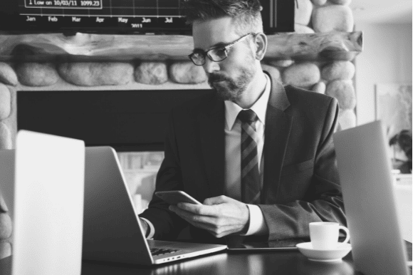 Finance manager working at his desk and researching options.