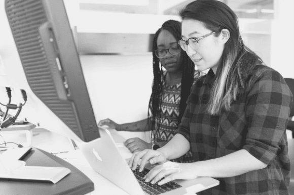 Help desk workers assisting a customer with a problem.