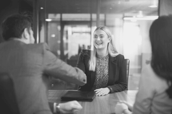 Young woman getting entry level interview questions in a conference room