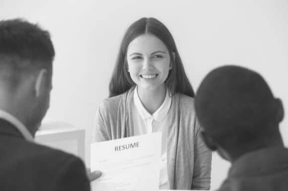 Managers conducting an interview with strategic questions in an office