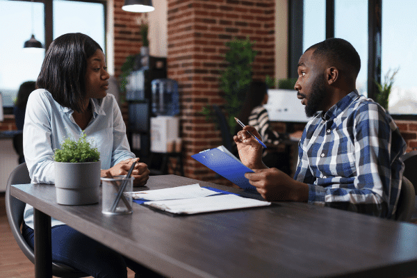 Two people are negotiating a salary offer after an informal interview in a cafe