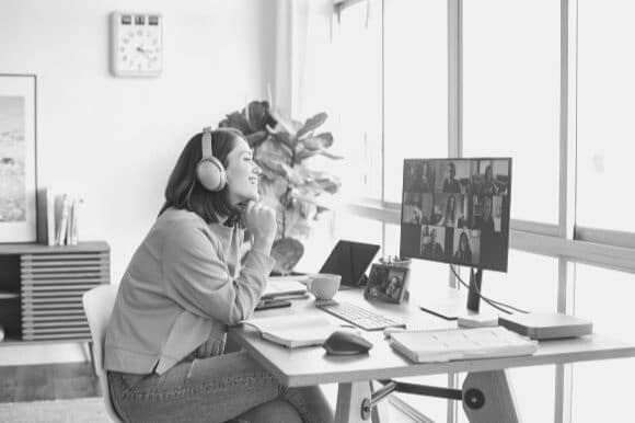 Woman in a hybrid workforce working from her home office