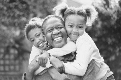 Babysitter playing with children outside