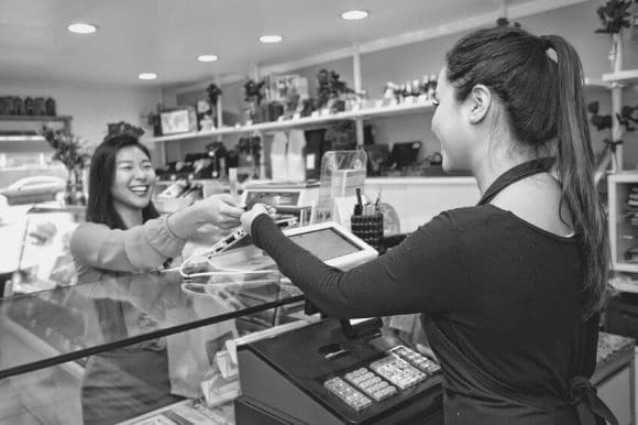 Cashier talking to customer across the counter