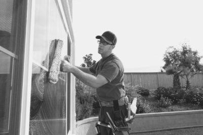 Cleaner washing a window outside