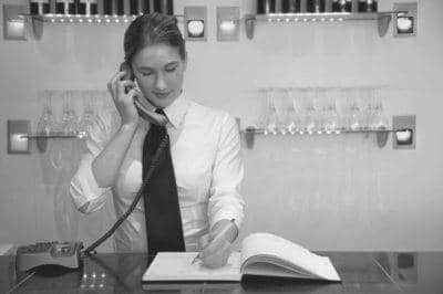Hostess on the phone in restaurant lobby